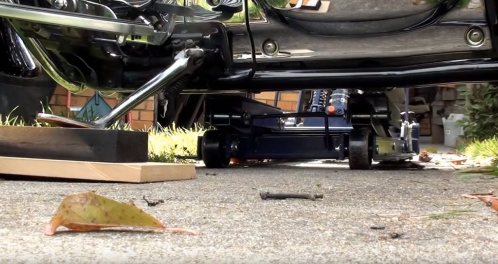 Use wood blocks to raise your motorcycle before jacking